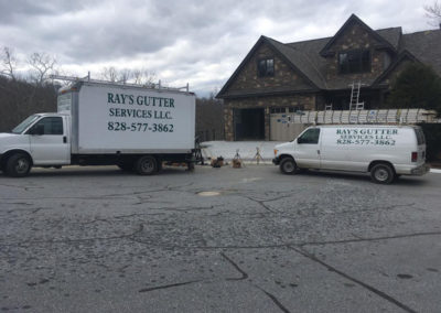 Ray's Gutter Services Vans in front of Residential Home